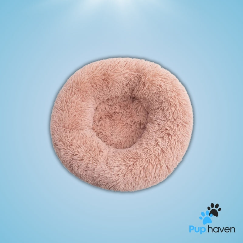 Pink Cozy plush round pet bed for dogs and cats, offering warmth and ultimate comfort.